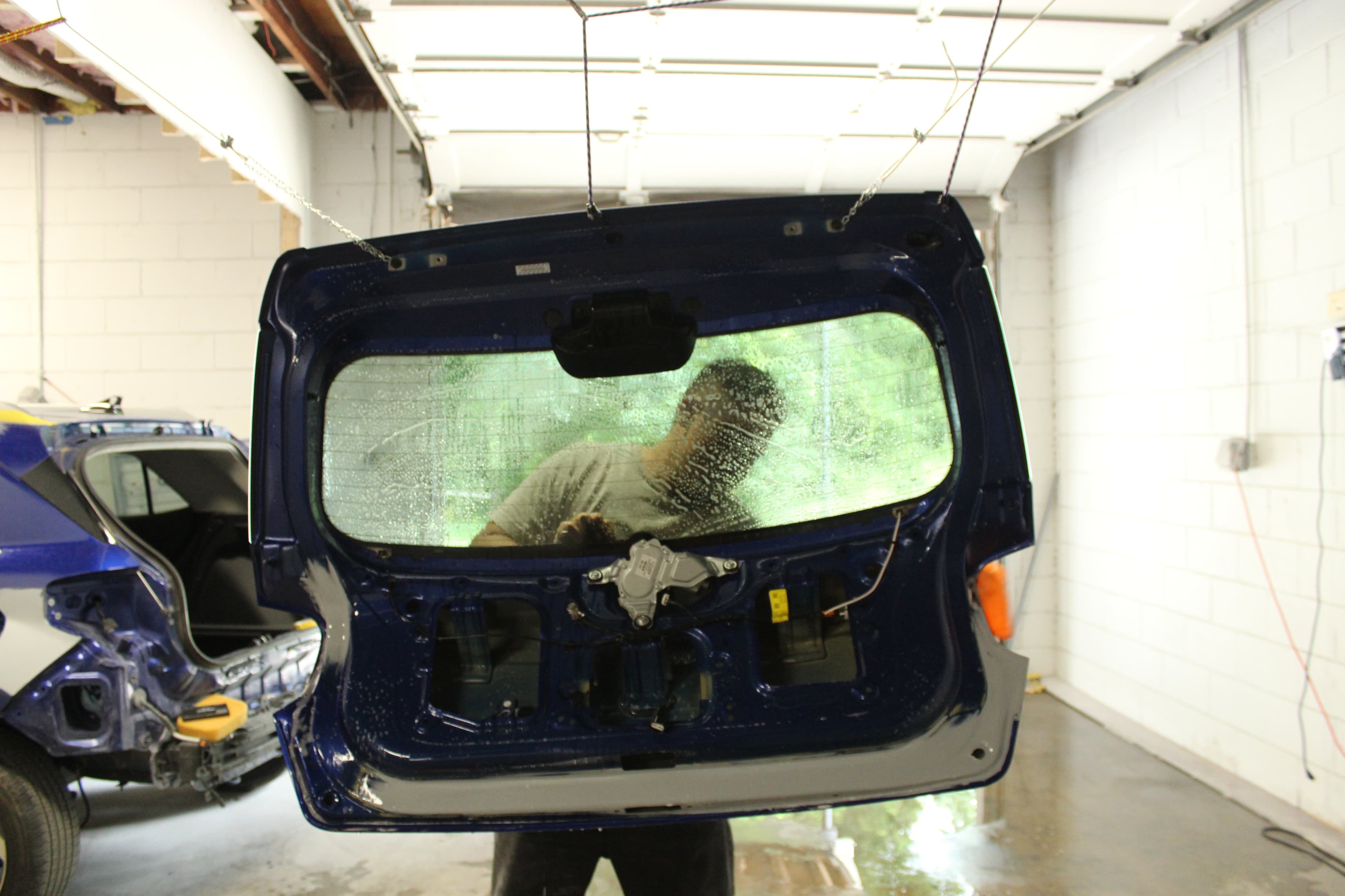 Technician working on a vehicle at Top Gear Body & Auto Center in Garner, NC